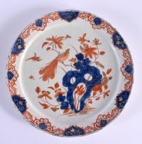 A RARE 18TH CENTURY DELFT IMARI TIN GLAZED ENAMEL PLATE painted with a bird perched amongst flowerin