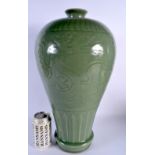 A LARGE CHINESE QING DYNASTY CELADON STONEWARE VASE decorated in relief with dragons. 45 cm x 18 cm.