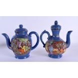 AN UNUSUAL PAIR OF JAPANESE TAISHO PERIOD NIKKI COMPANY LTD POTTERY TEAPOTS decorated with figures.