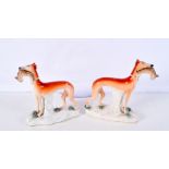 A pair of 19th Century Staffordshire greyhounds carrying hares largest 20 cm (2).