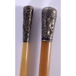 TWO 19TH CENTURY CHINESE CARVED RHINOCEROS HORN SILVER MOUNTED SWAGGER STICKS Qing. 125 grams. Large