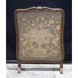 An antique wooden framed embroidered fire screen 88 x 82 cm.