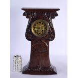 A LARGE ARTS AND CRAFTS OAK MANTEL CLOCK carved with a roaming frog amongst thistles. 45 cm x 22 cm.