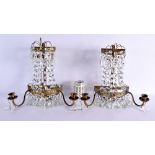 A PAIR OF WALL MOUNTED GILT METAL DEMI LUNE TWIN BRANCH SCONCES with cut glass lustres. 38 cm x 36 c