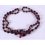 A CHERRY AMBER TYPE NECKLACE. 81cm long, largest bead 15.4mm