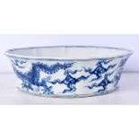 A Chinese porcelain blue and white petal shaped bowl decorated with a dragon 5.5 x 19 cm.