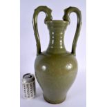 A CHINESE QING DYNASTY TWIN HANDLED STONEWARE CELADON VASE incised with flowers. 40 cm x 17 cm.