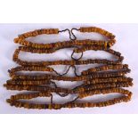 FIVE MIDDLE EASTERN CARVED AMBER PRAYER BEAD NECKLACES. 535 grams. 64 cm long. (5)