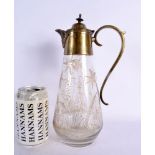 AN AESTHETIC MOVEMENT ENGRAVED GLASS CLARET JUG. 27 cm high.