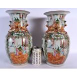 A PAIR OF 19TH CENTURY CHINESE CANTON FAMILLE ROSE VASES Qing, painted with figures. 35 cm x 15 cm.