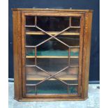 A wooden and glass fronted oak hanging corner cabinet 89 x 77 .