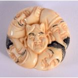 A JAPANESE CARVED BONE MASK NETSUKE. 4 cm wide.