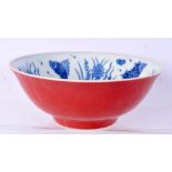 A Chinese porcelain blue and white bowl decorated with fish to the interior. The exterior red glaze