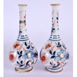 A SMALL PAIR OF CHINESE QING DYNASTY BLUE AND WHITE VASES painted with flowers. 13 cm high.