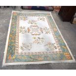 A large Indian wool rug 338 x 249 cm.