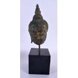 A 17TH/18TH CENTURY THAI BRONZE BUDDHA HEAD upon a later plinth. 27 cm high.