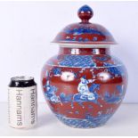 A Chinese porcelain Copper red ground ginger jar and cover decorated with figures 29 cm.