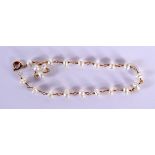 A 20TH CENTURY LADIES PEARL AND GOLD BRACELET with 20 natural pearls mounted upon a delicate gold c