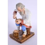 A 19TH CENTURY RUSSIAN IMPERIAL PORCELAIN FIGURE OF A SHOE MENDER. 16 cm x 9 cm.