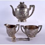 A 19TH CENTURY CHINESE EXPORT FOUR PIECE SILVER TEASET by Wang Hing, decorated in relief with birds