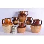 A 19TH CENTURY DOULTON STONEWARE HUNTING JUGS together with five others. Largest 25.5 cm high. (6)