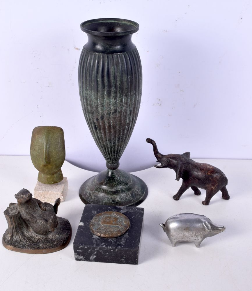A Norwegian bronze vase together with a metal elephant, Easter Island stone head, D P Carter pig et