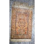 A MIDDLE EASTERN SILK RUG decorated with foliage. 75 cm x 40 cm.