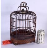 A LARGE CHINESE REPUBLICAN PERIOD CARVED BAMBOO BIRD CAGE with porcelain bird feeder. 36 cm x 20 cm.