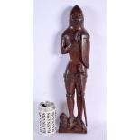 AN ARTS AND CRAFTS CARVED WOOD FIGURE OF A SOLDIER modelled standing upon a lion. 45 cm high.