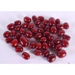 A COLLECTION OF EUROPEAN ART DECO RED BEADS probably Faturan or cherry amber. 460 grams. Largest 3.5