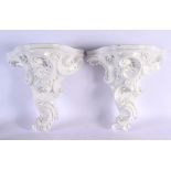 A PAIR OF VINTAGE FRENCH WHITE GLAZED POTTERY WALL BRACKETS. 32 cm x 24 cm.