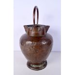 An antique double spouted hammered copper water jug 41 cm.