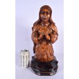A LATE 19TH CENTURY CONTINENTAL CARVED WOOD FIGURE OF A SAINT modelled with hands clasped. 40 cm x 1