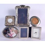 THREE SILVER MOUNTED PHOTOGRAPH FRAMES together with two silver clocks. London 1921, 1970 & 1995. 67