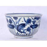 A Chinese porcelain blue and white bowl decorated with fish and algae 11 x 18.5 cm.