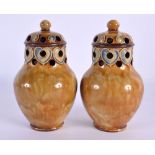 A PAIR OF ROYAL DOULTON STONEWARE PEPPERETTES. 12 cm high.