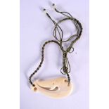 A MAORI STYLE CARVED BONE TRIBAL FISH HOOK TYPE NECKLACE. Pendant 5.5 cm x 3.5 cm.