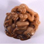 A CHINESE EROTIC JADE ROUNDEL 20th Century. 4 cm x 3 cm.