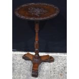 A carved yew wood tilt top side table possibly Isle of man 71 x 41 x 33 cm.