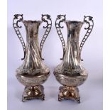 A PAIR OF TWIN HANDLED CONTINENTAL SILVER VASES. 1661 grams overall. 30 cm x 13 cm.