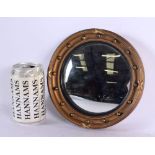 A MINIATURE REGENCY STYLE GILT MIRROR. 16.5 cm diameter.