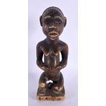 AN AFRICAN TRIBAL CARVED WOOD FIGURE. 21 cm high.