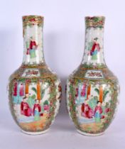 A PAIR OF 19TH CENTURY CHINESE CANTON FAMILLE ROSE VASES painted with figures. 26 cm high.