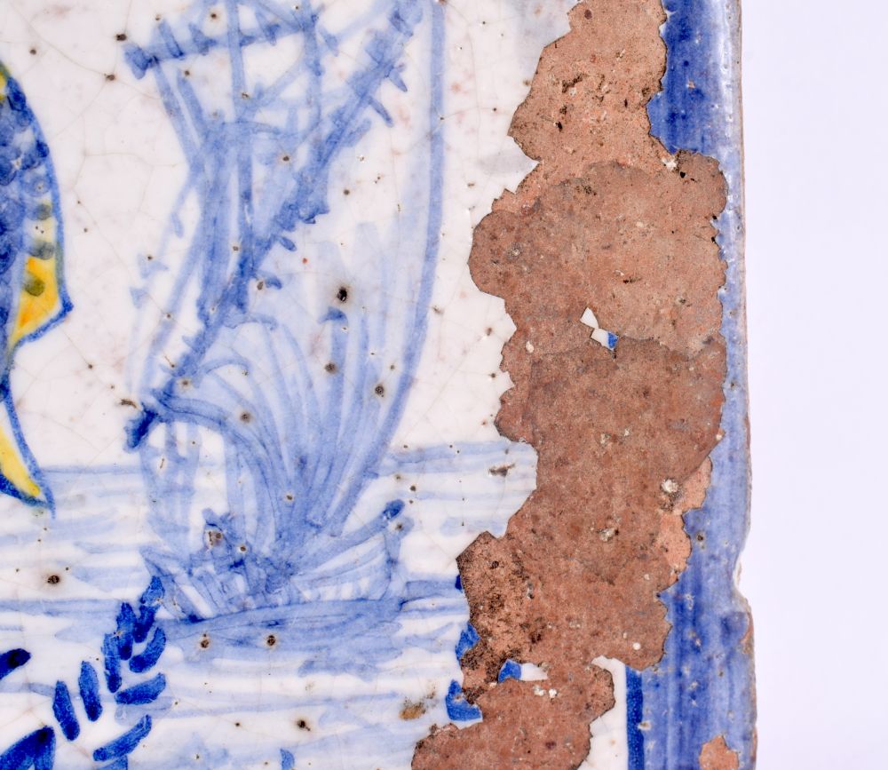 A RARE 18TH CENTURY EUROPEAN FAIENCE TIN GLAZED SQUARE TILE painted with a winged female holding fis - Image 3 of 5