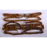 FIVE MIDDLE EASTERN CARVED AMBER PRAYER BEAD NECKLACES. 711 grams. 64 cm long. (5)