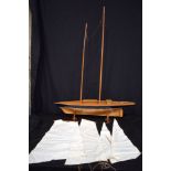 A large wooden model yacht 115 x 91 cm.