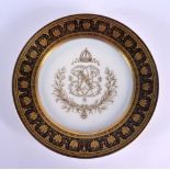 AN EARLY 20TH CENTURY FRENCH SEVRES PORCELAIN ARMORIAL PLATE painted with a blue banding. 23 cm diam