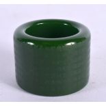 A CHINESE CARVED GREEN JADE ARCHERS RING 20th Century. 3.5 cm wide.