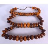 THREE LARGE MIDDLE EASTERN CARVED AMBER BOULDER NECKLACES. 1460 grams. 68 cm long. (3)