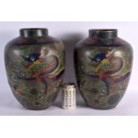 A PAIR OF 17TH/18TH CENTURY CHINESE CLOISONNE ENAMEL VASES decorated with dragons amongst foliage. 3